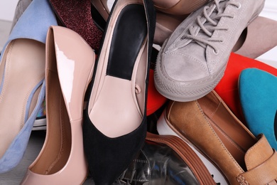 Photo of Large heap of different modern shoes, closeup