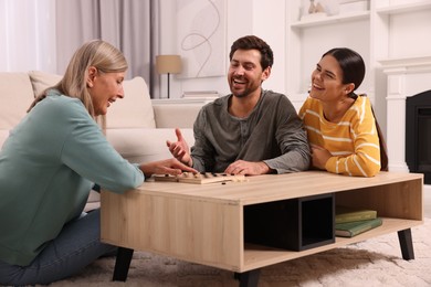 Photo of Family talking while playing checkers at home
