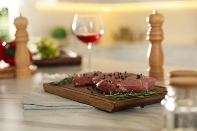 Photo of Raw meat steaks on table in kitchen. Cooking food