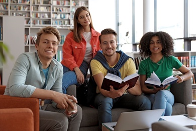 Photo of Group of young people studying at table in library