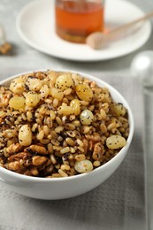 Photo of Traditional Christmas slavic dish kutia in bowl on napkin, closeup