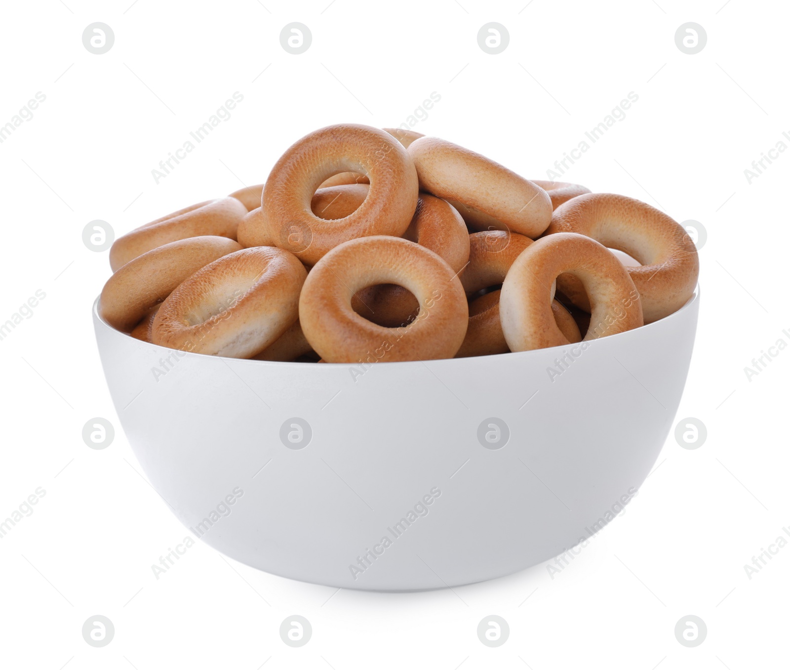 Photo of Bowl with tasty dry bagels (sushki) isolated on white