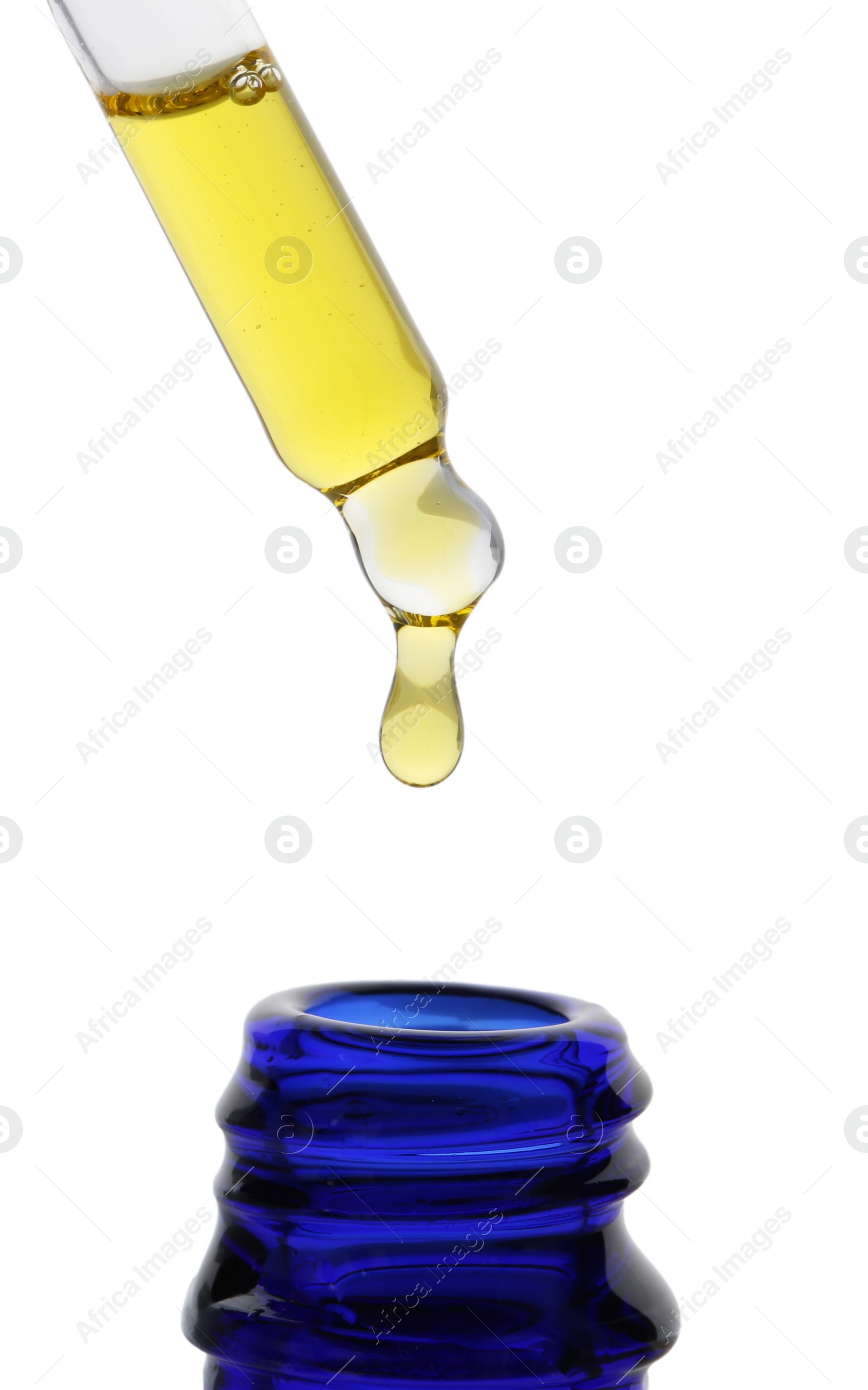 Photo of Dripping tincture from pipette into bottle isolated on white