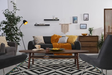 Photo of Stylish living room interior with comfortable sofa and wooden table