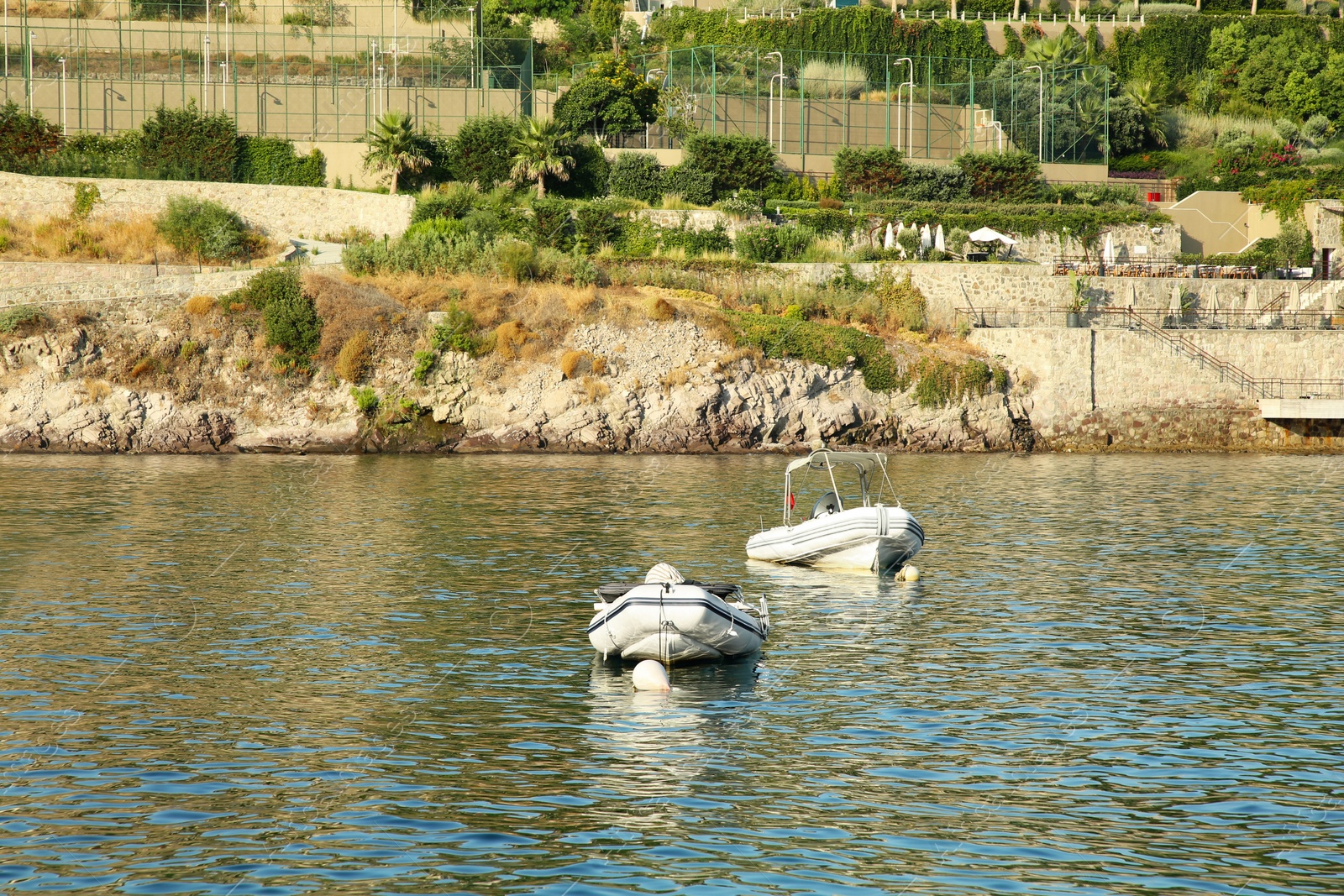 Photo of Inflatable boats on sea near coastal city