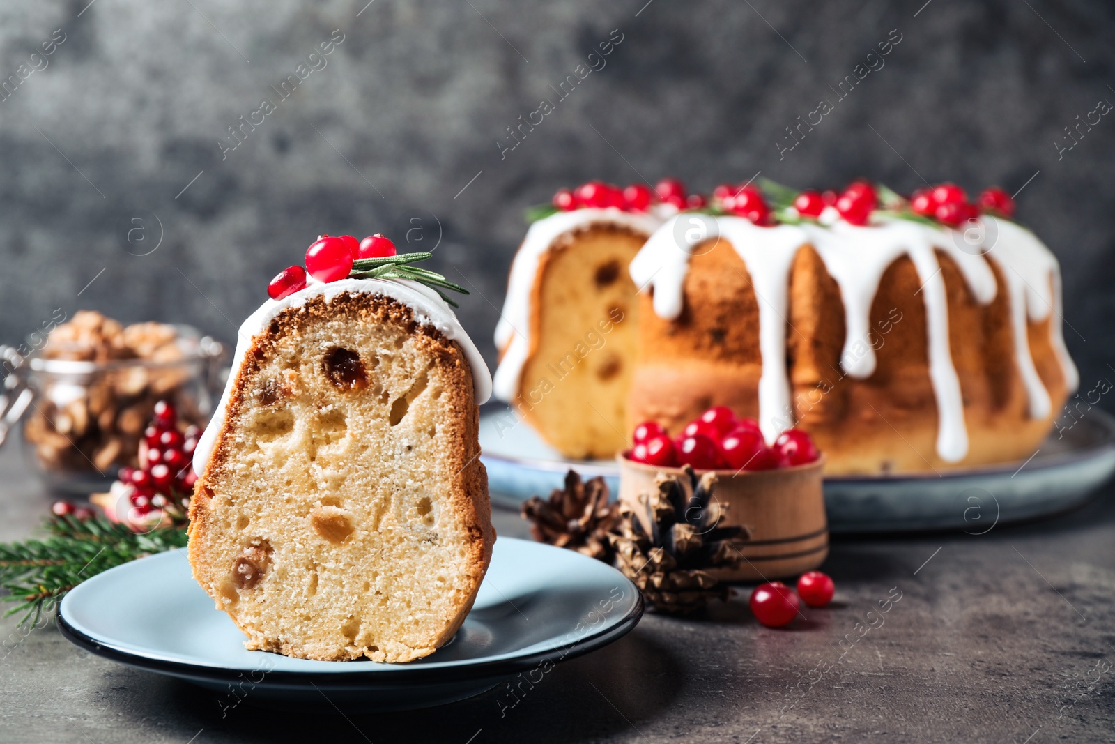 Photo of Composition with piece of traditional homemade Christmas cake on grey table, closeup