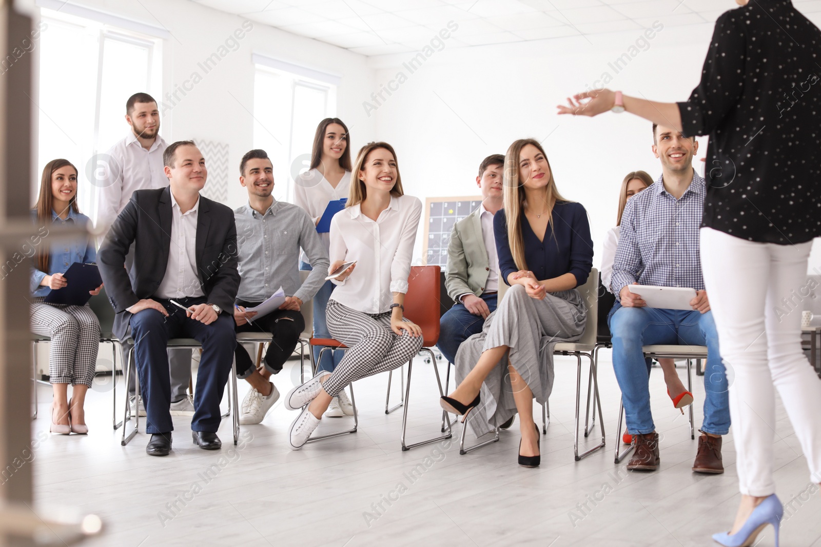 Photo of Female business trainer giving lecture in office