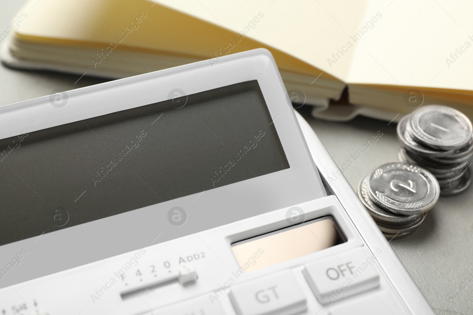 Photo of Calculator, notebook and money on grey table, closeup. Tax accounting