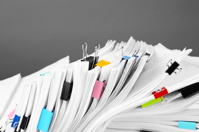 Photo of Pile of documents with colorful binder clips, closeup