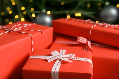 Photo of Beautiful gift boxes and blurred Christmas tree on background