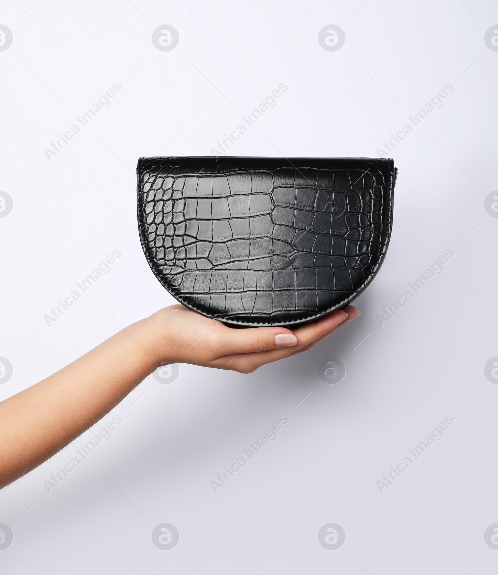 Photo of Woman holding stylish bag on light background, closeup