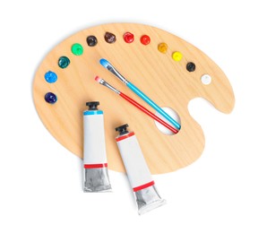 Photo of Palette with acrylic paints and brushes on white background, top view. Artist equipment