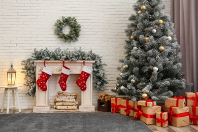 Stylish Christmas interior with decorated fir tree and fireplace