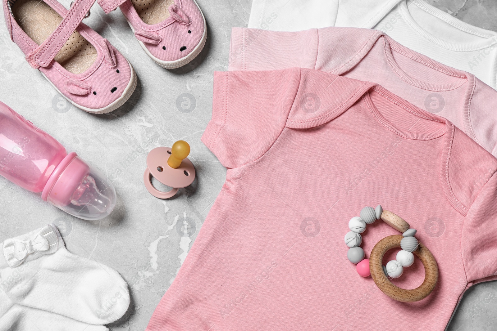 Photo of Flat lay composition with cute baby items on grey background