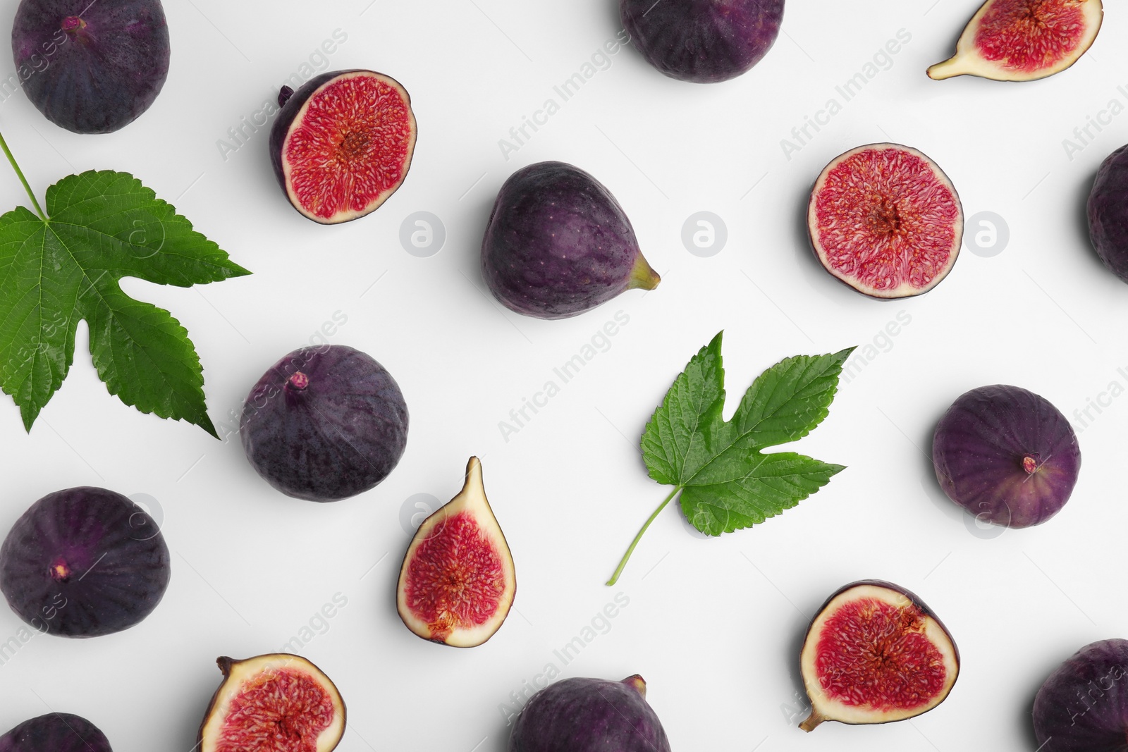 Photo of Fresh ripe figs with green leaves on white background