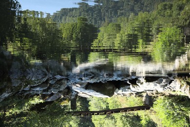 Photo of Beautiful view of small river under wooden bridge outdoors