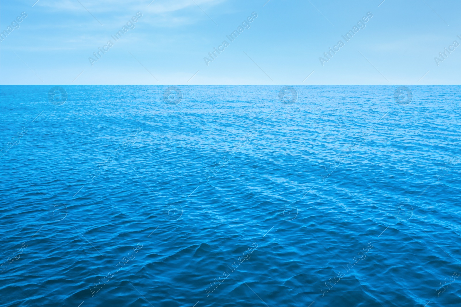 Image of Beautiful ripply sea under blue sky with clouds