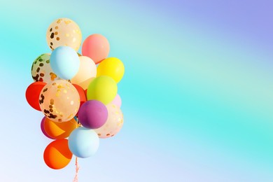 Image of Many bright balloons on color background, space for text. Summer party