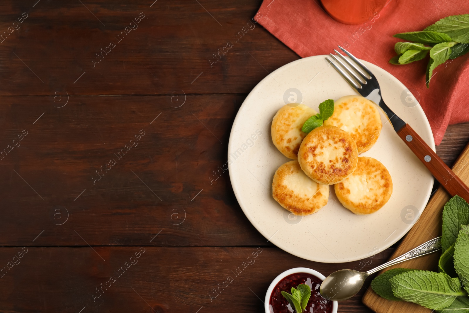 Photo of Delicious cottage cheese pancakes with mint on wooden table, flat lay. Space for text