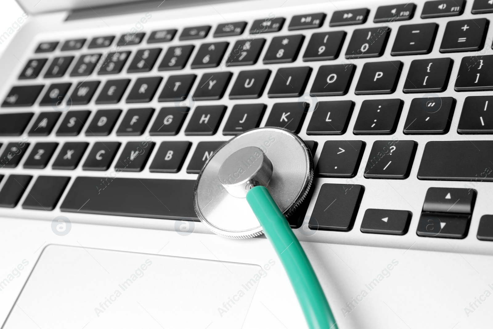 Photo of Laptop with stethoscope, closeup view. Computer repair