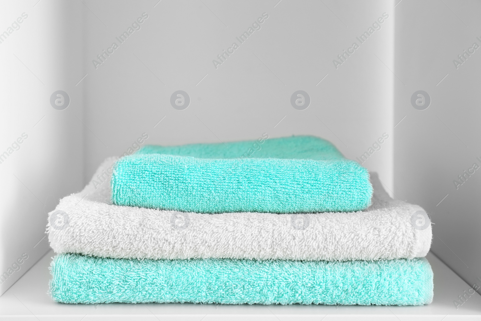 Photo of Stack of clean towels on shelf