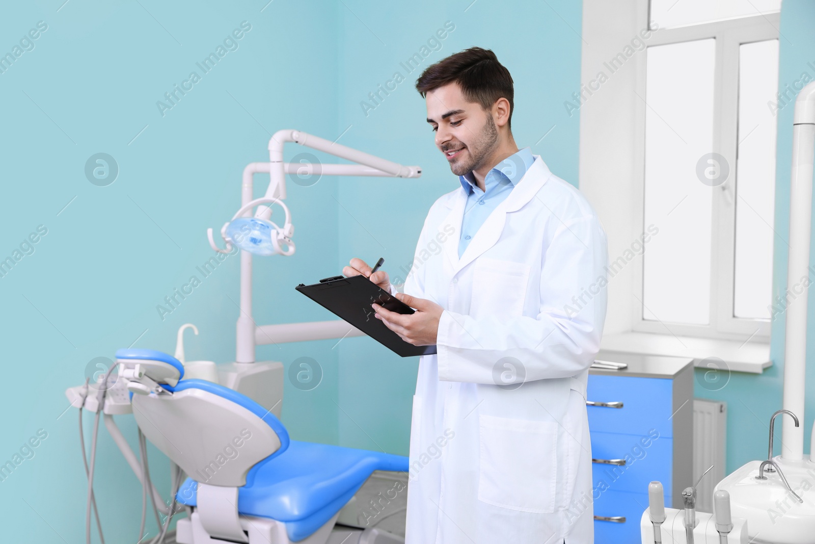 Photo of Portrait of male dentist in modern clinic