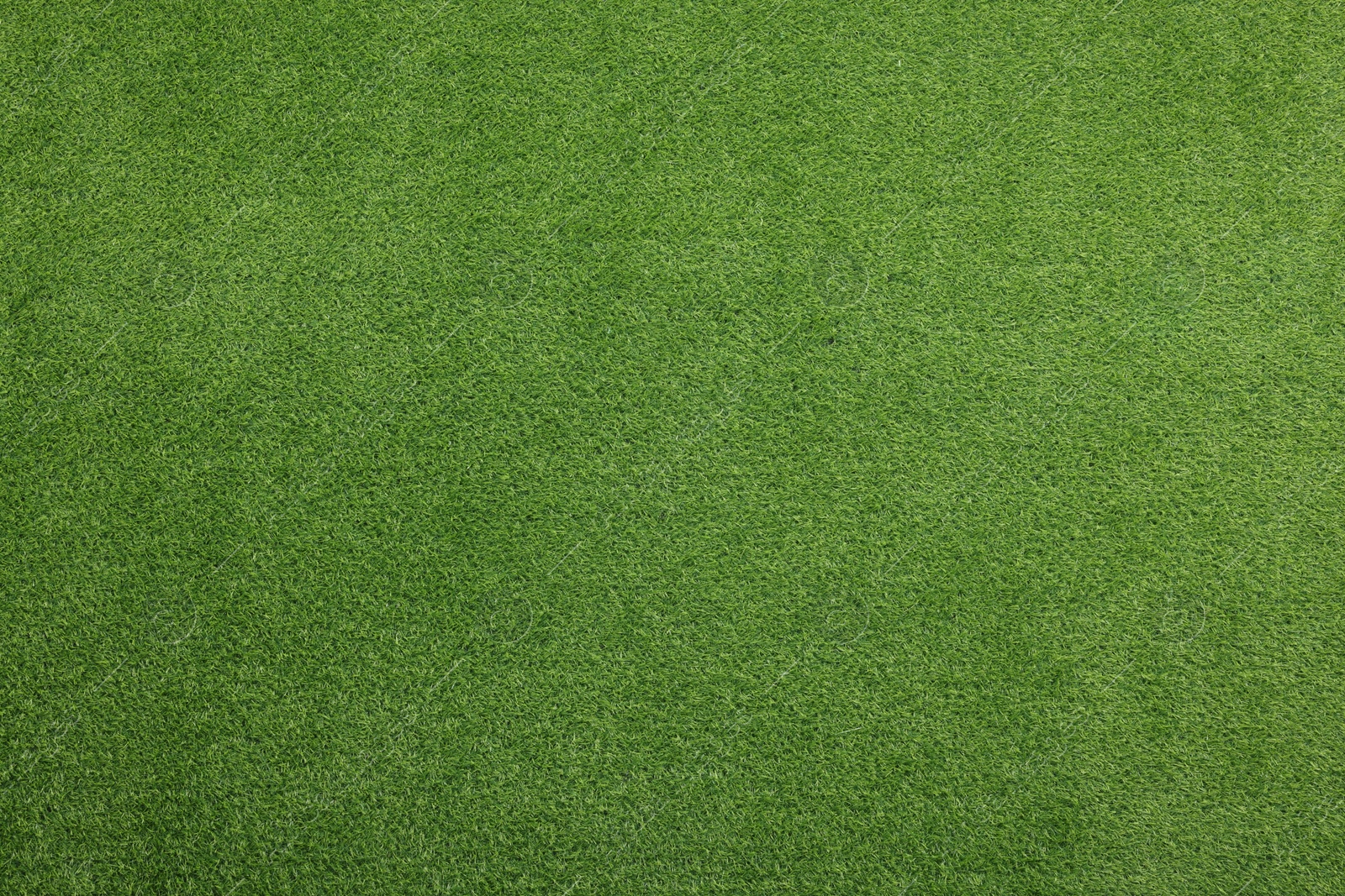 Photo of Green artificial grass as background, top view