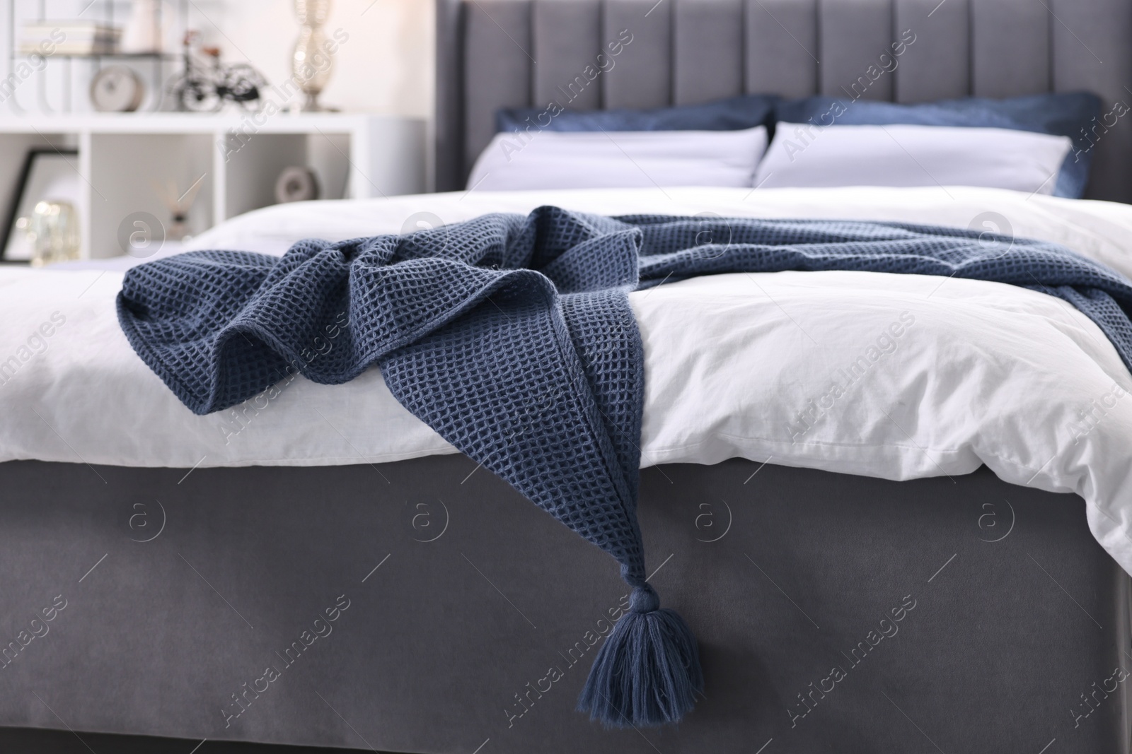 Photo of Soft blue plaid on bed in room