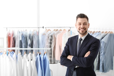 Photo of Portrait of young businessman at dry-cleaner's