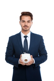 Young businessman with piggy bank on white background