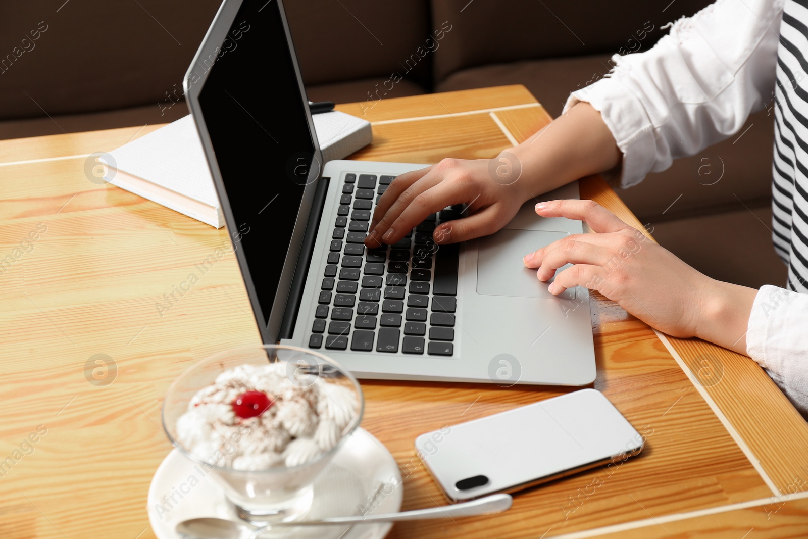 Photo of Blogger working with laptop in cafe, closeup