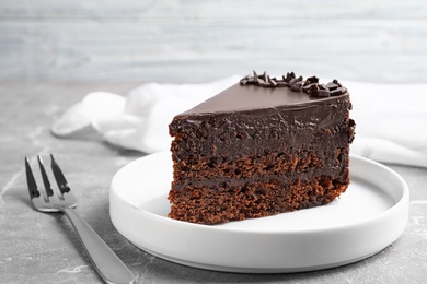 Photo of Delicious fresh chocolate cake served on grey table, closeup