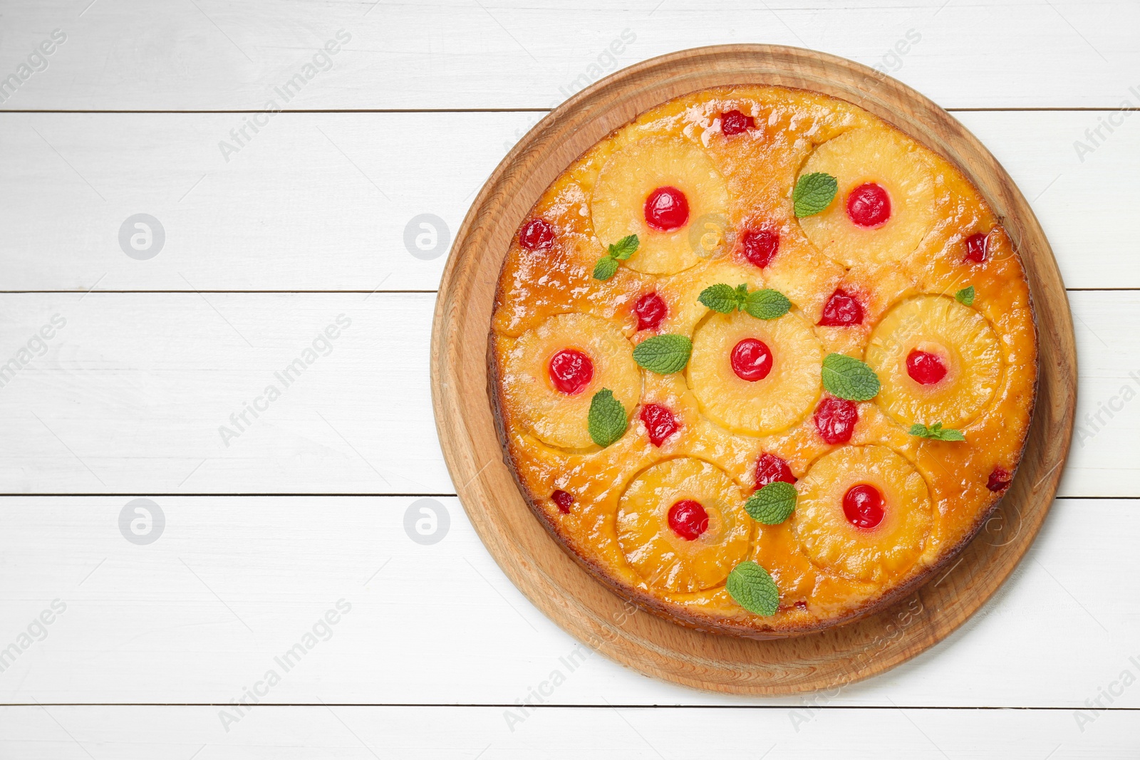 Photo of Delicious pineapple pie with cherry and mint on white wooden table, top view. Space for text