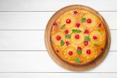 Delicious pineapple pie with cherry and mint on white wooden table, top view. Space for text