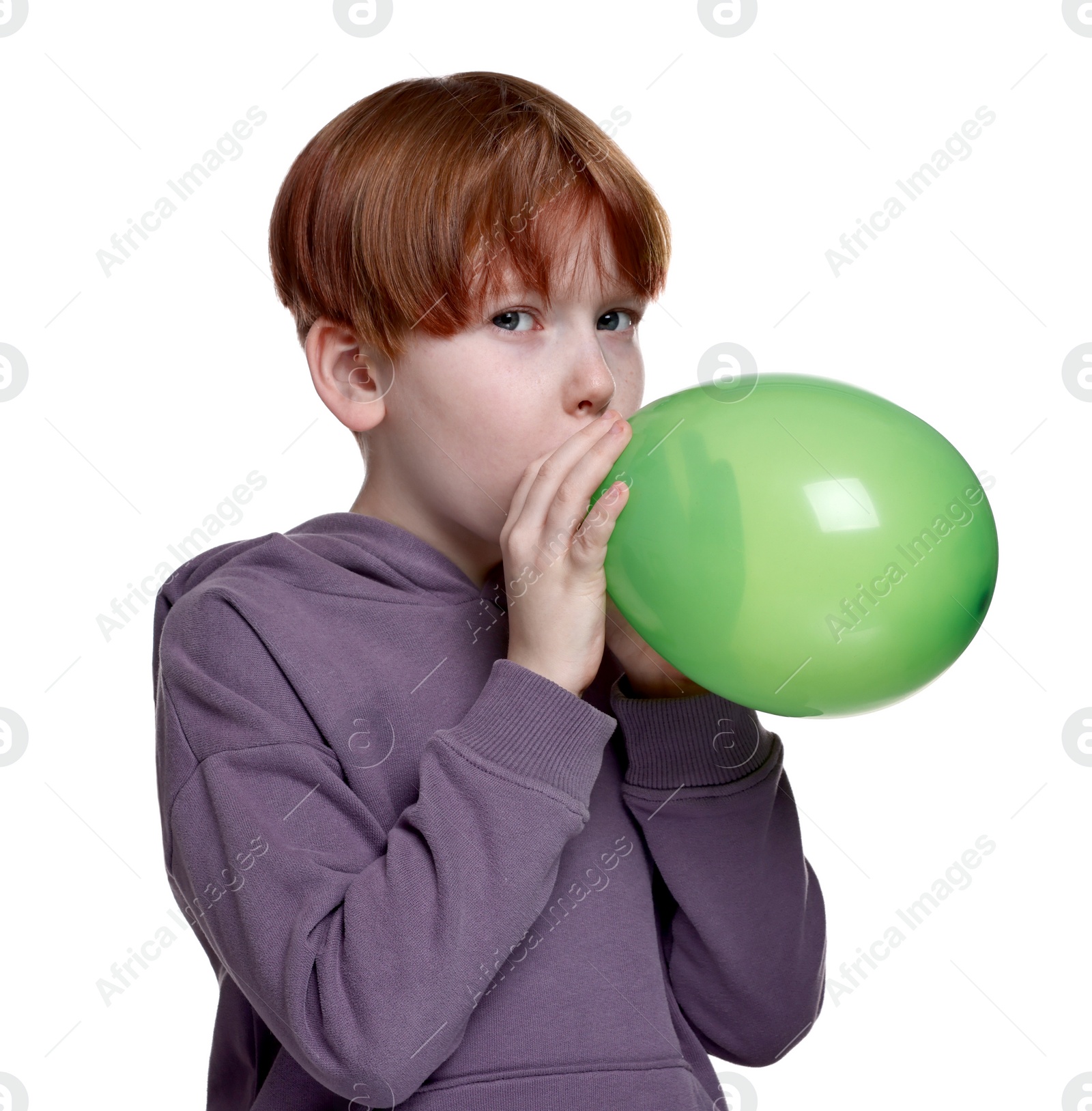 Photo of Boy inflating green balloon on white background