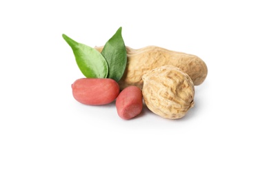 Raw peanuts and leaves on white background. Healthy snack