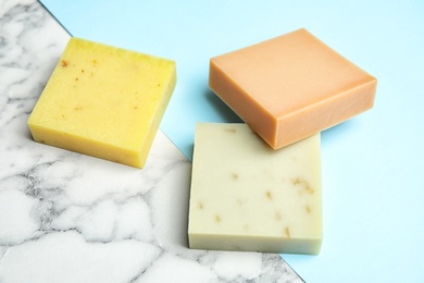 Photo of Different handmade soap bars on marble table