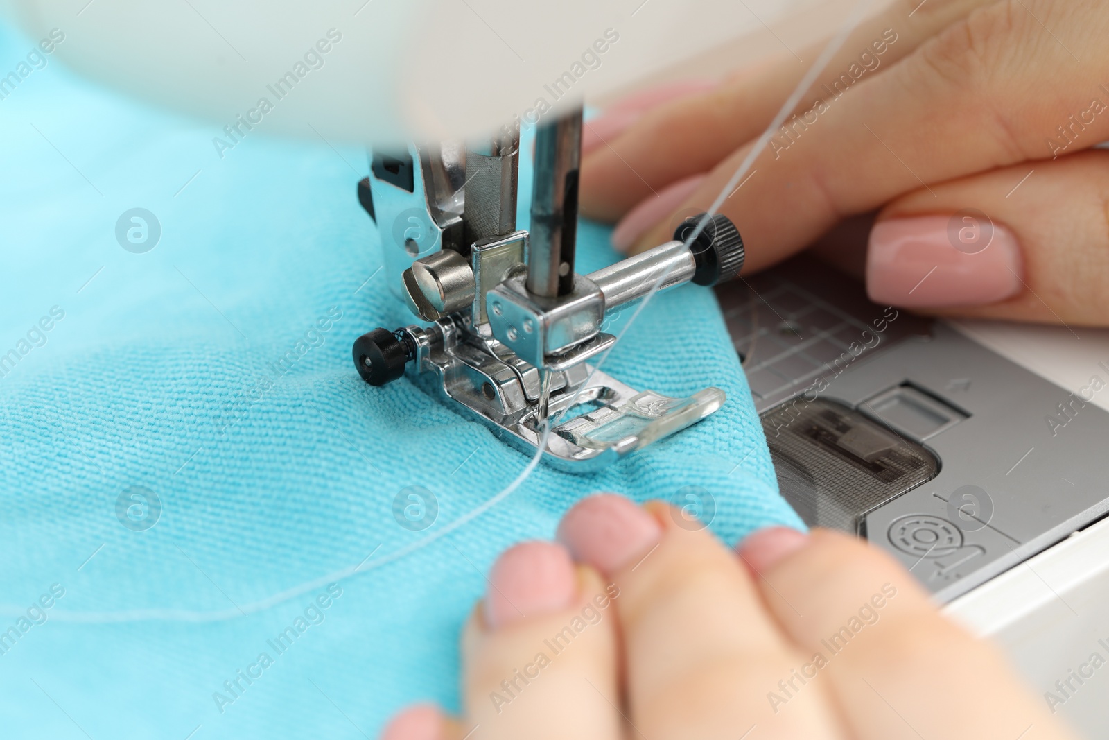 Photo of Seamstress working with sewing machine, selective focus