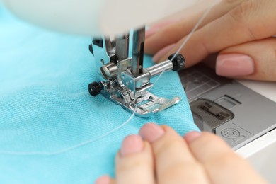 Photo of Seamstress working with sewing machine, selective focus