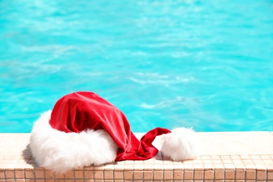 Photo of Authentic Santa Claus hat near pool at resort