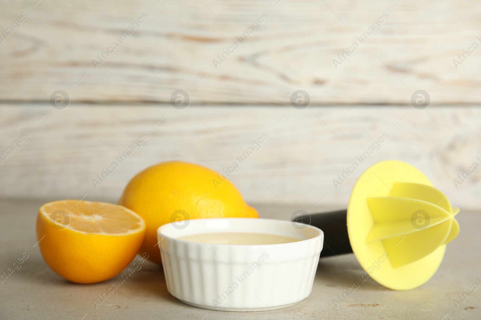 Photo of Freshly squeezed lemon juice on light grey table