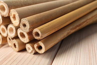 Photo of Pile of dry bamboo sticks on wooden table