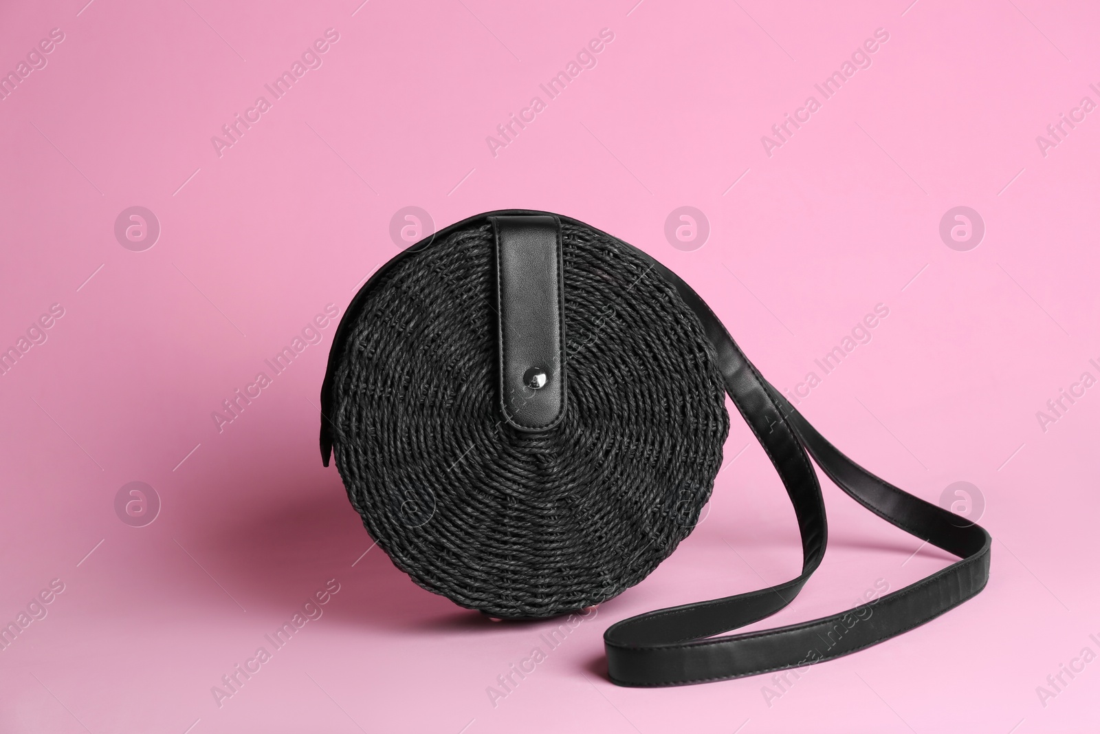 Photo of Stylish woman's bag on light pink background