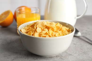 Photo of Bowl with healthy cornflakes for breakfast served on table, closeup