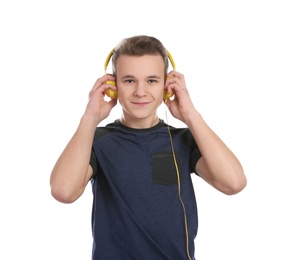 Photo of Teen boy listening to music with headphones on white background