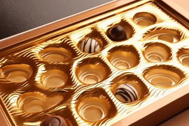 Photo of Partially empty box of chocolate candies, closeup