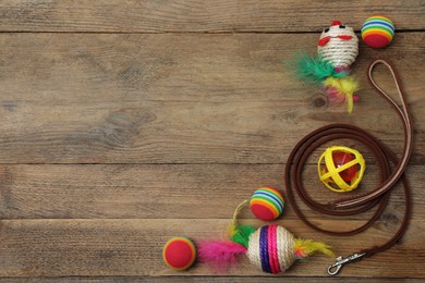 Photo of Flat lay composition with pet leash and toys on wooden background, space for text