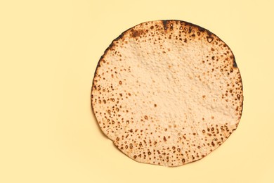 Photo of Tasty matzo on beige background, top view with space for text. Passover (Pesach) celebration