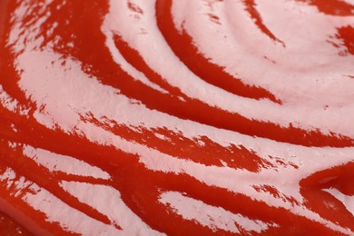 Photo of Tasty ketchup as background, closeup. Tomato sauce