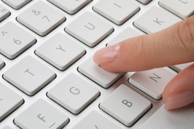 Photo of Woman pressing button on computer keyboard, closeup